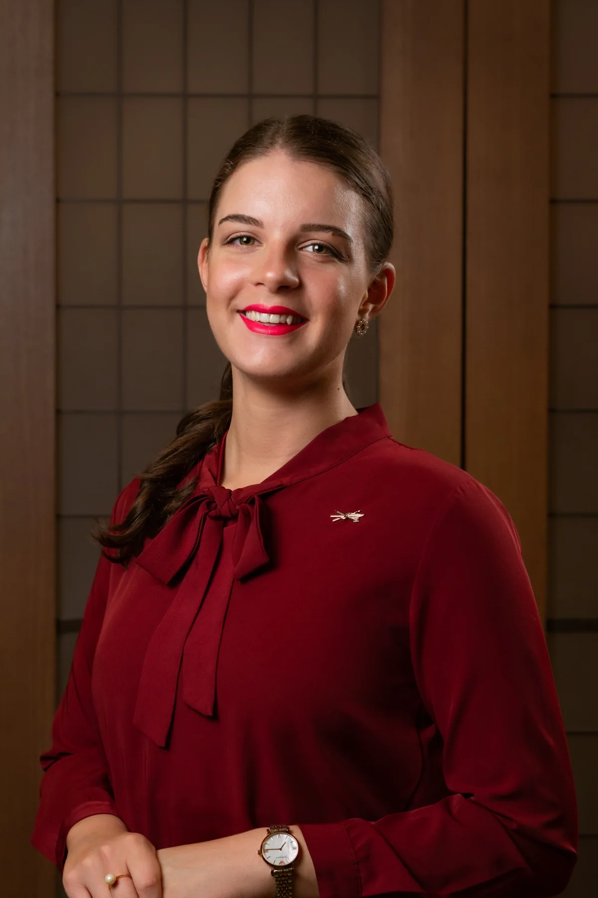Smiling professional in red photographed at Hotel Café Royal
